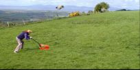 An idiot mowing a field