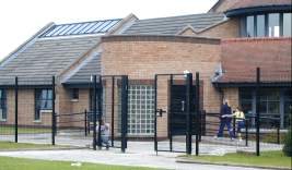 Building a black fence around the medical centre