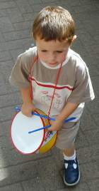 A little boy playing the drum