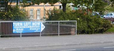 A Turn Left Now sign