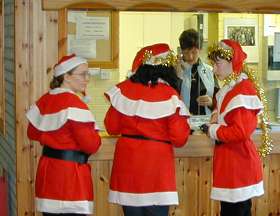 Three female Santas at reception